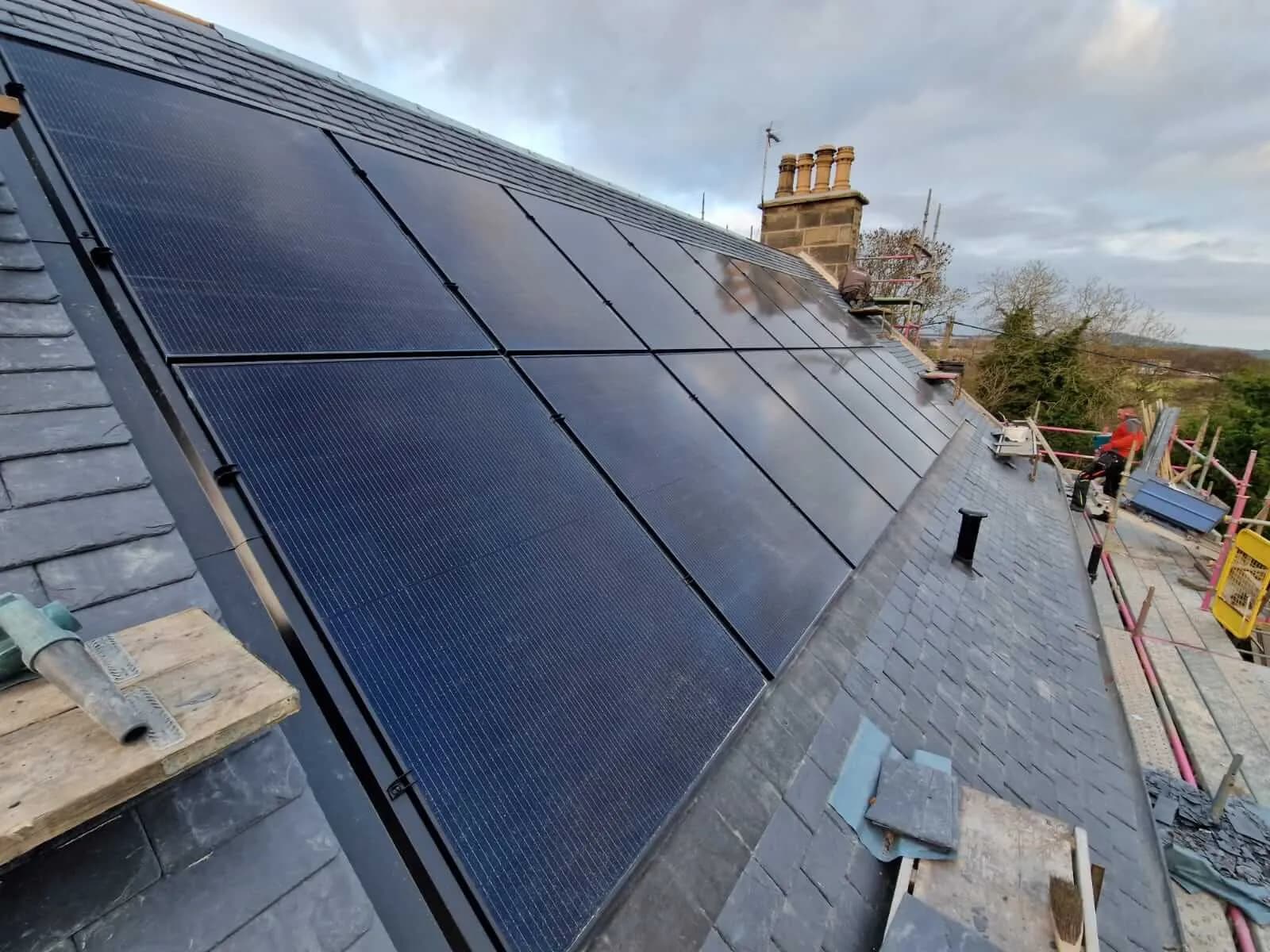 Roof-integrated all-black solar panels installed on a natural slate roof at Avonmuir House