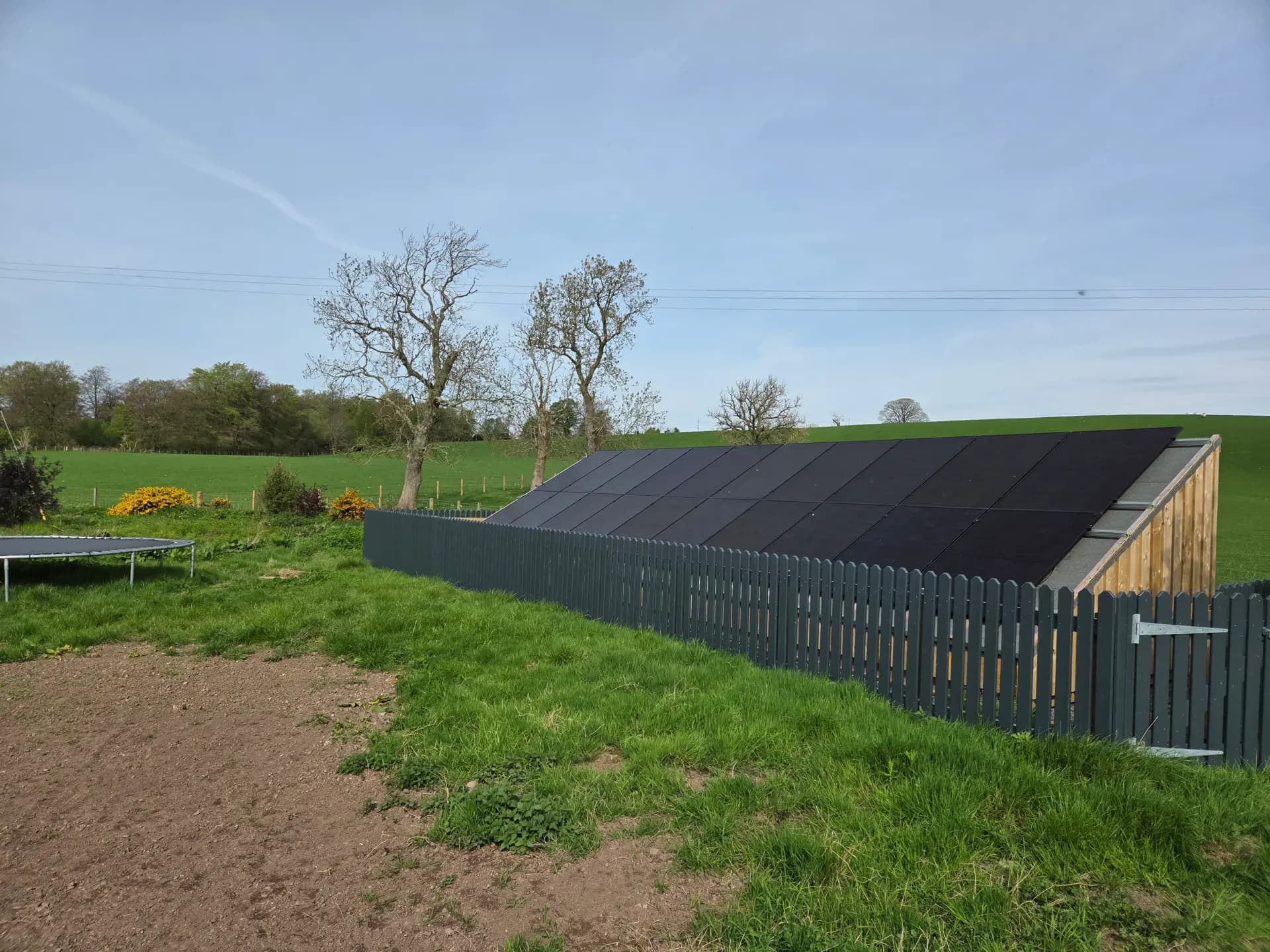 Bespoke ground-mounted solar array over a timber garden store in Blair Drummond