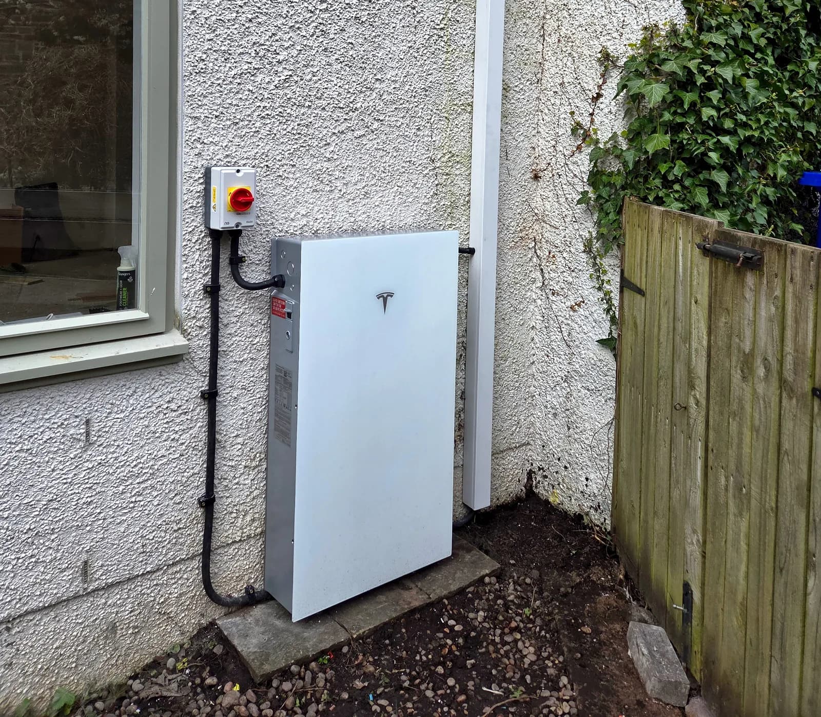 Tesla Powerwall 3 battery storage mounted on an external wall at a property in Dunblane