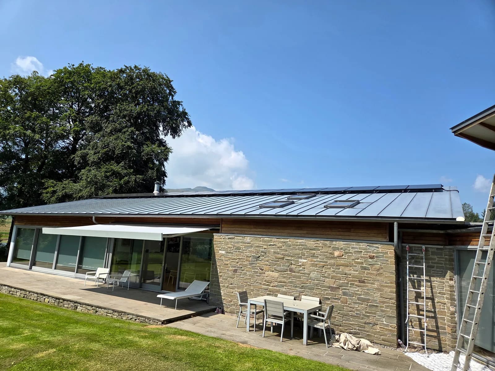 Solar panels installed on a standing seam roof near Loch Venachar, Callander