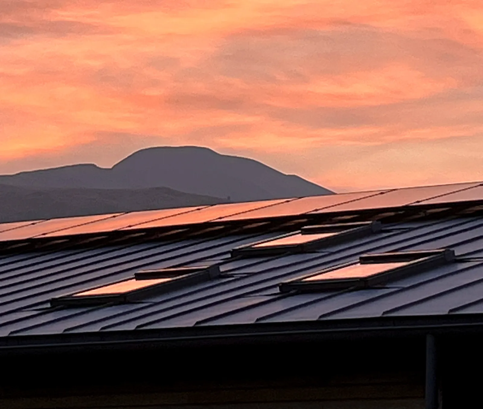 Golden-hour sky behind a completed solar installation near Loch Venachar, Callander